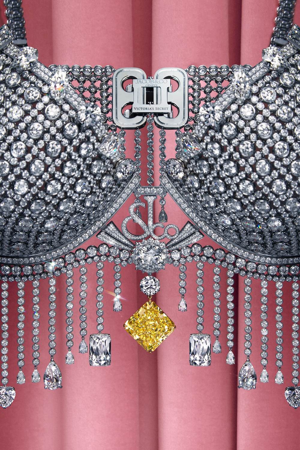 Macro detail of the Fantasy Bra: the 75.54-carat radiant-cut Fancy Vivid Yellow diamond hanging below the Jacob & Co. clasp, surrounded by white diamonds